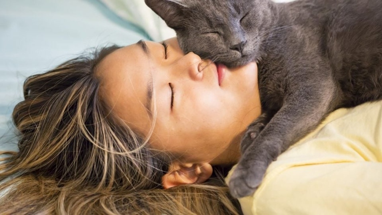 Cats sleep pressed up against their owners for warmth and security, and the hormones released during petting can help to create a bond between the two.